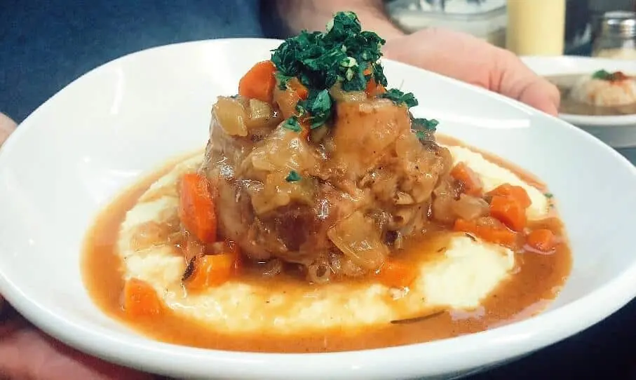 Braised meat and vegetables over creamy grits